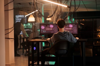 cybercriminal-attacking-imortant-database-hacker-using-computer-virus-malware-break-into-server-woman-committing-cybercrime-phishing-scam-working-monitors-late-night