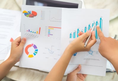 top-view-workers-checking-statistical-documents
