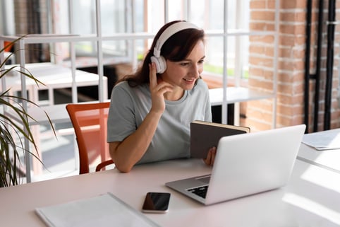 woman-working-with-headphones-medium-shot